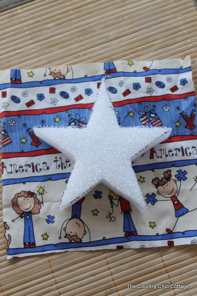 A great buttons and stars garland for your summer or 4th of July decor. Come see how to make this craft with Styrofoam, fabric, and buttons. square shape cut out of fabric for layout of the star for the patriotic garland