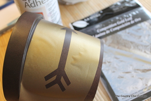 Add a gold leaf touch to metal flower pots with this easy to follow tutorial. Gold leaf is easy to use and makes a bold statement.