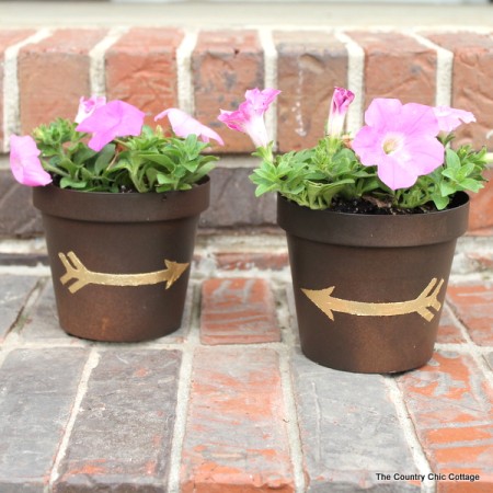 Gold leaf metal flower pot with flowers