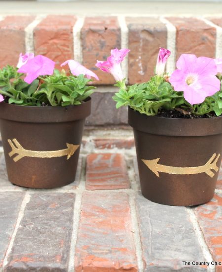 Gold leaf metal flower pot with flowers