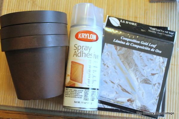 Add a gold leaf touch to metal flower pots with this easy to follow tutorial. Gold leaf is easy to use and makes a bold statement. Gold leaf flower pot supplies.
