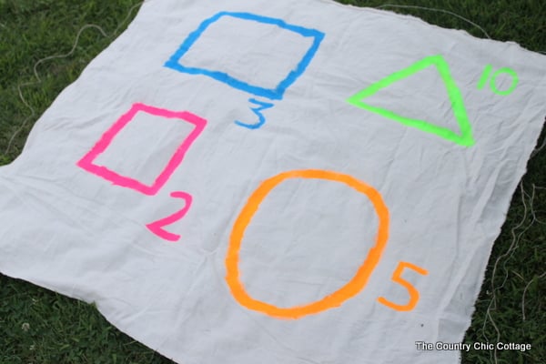 Glow in the Dark Yard Game -- make a summer of fun memories by adding yard games to your backyard or party. This glow in the dark game does not have to stop when the sun goes down! yard game with neon paints
