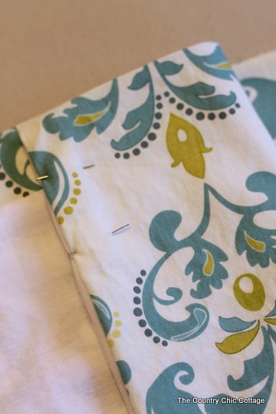 Placing pins in your curtain fabric makes sewing them much easier