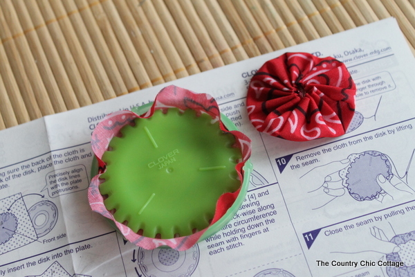 Burlap Yoyo Candle Wraps -- perfect for 4th of July, summer, or change up the colors for any season. Click to get a full tutorial on how to make these great home decor accessories. fabric yoyo maker