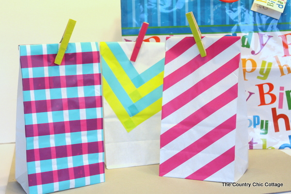 DIY Gift Bags -- 3 ways to turn a plain white lunch sack into a gift bag using just tape. A super quick and easy way to update your gifts and make them extra special.