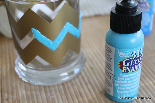 Chevron Beach Themed Candle Holders -- use glass paints to create these great candle holders in minutes. Bring a bit of the beach indoors this summer and add a nautical flair to your decor. Plus there is also a $200 giveaway to enter in this post! Painting chevron designs with gloss paint.