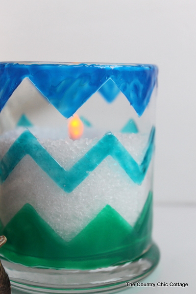 Chevron Beach Themed Candle Holders -- use glass paints to create these great candle holders in minutes. Bring a bit of the beach indoors this summer and add a nautical flair to your decor. Plus there is also a $200 giveaway to enter in this post! Finished beach themed candle holder with salt and candle.