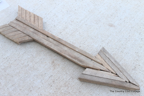 Use reclaimed wood sticks to make this extra large rustic wood arrow for your home today.