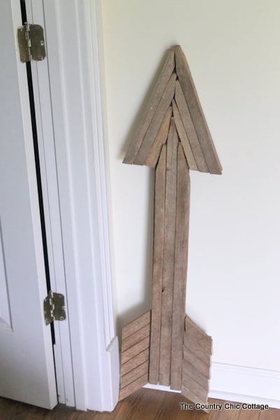 Use reclaimed wood sticks to make this extra large rustic wood arrow for your home today.