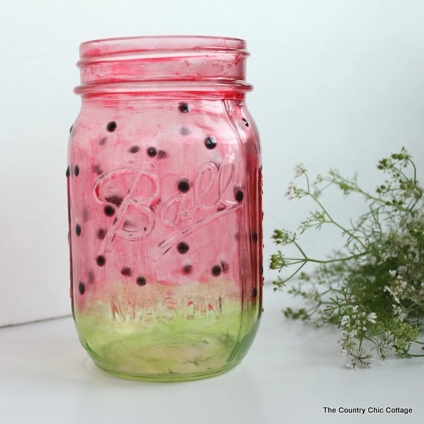 Watermelon Mason Jar -- learn how to paint a great watermelon mason jar craft for summer. Perfect for decorating your home or for parties. The jar turns out see through so you can add candles easily.