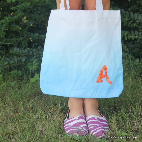 Woman holding a DIY monogram tote bag,