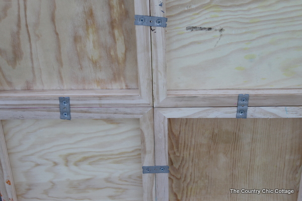closeup of metal brackets holding wood squares together