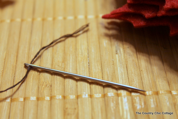 floss threaded through a large needle