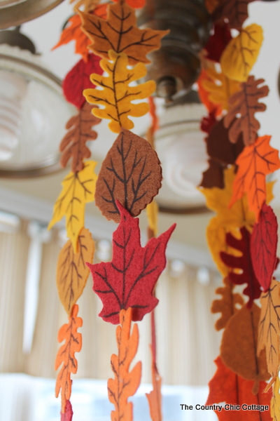 Fall Felt Leaf Garland -- add this to your fall decor. Super simple to make with pre-cut felt leaves and some thread. Come get the full instructions. closeup of finished Fall Felt Leaf Garland