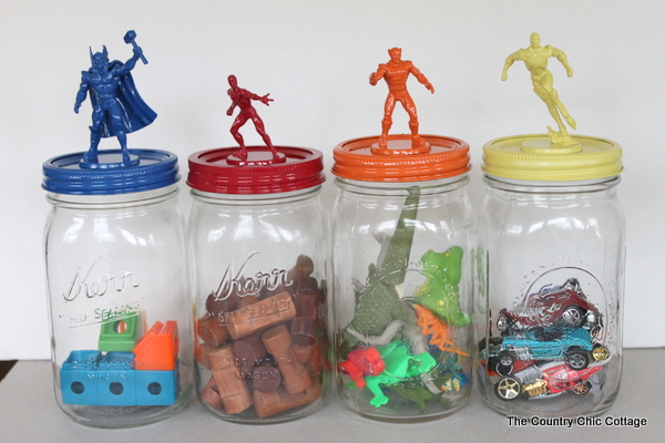 Make great super hero jar toy storage in minutes with this super simple tutorial. Plus learn all about the new Super Buddies movie from Disney. decorative mason jar lids with superheros