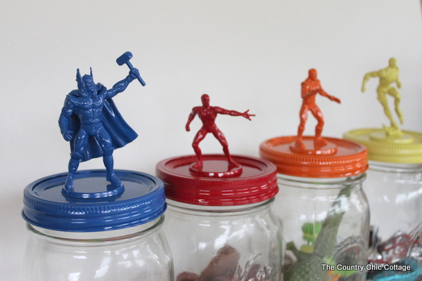 superhero figures on top of jars