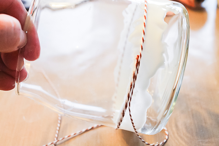 wrapping twine around a glass jar