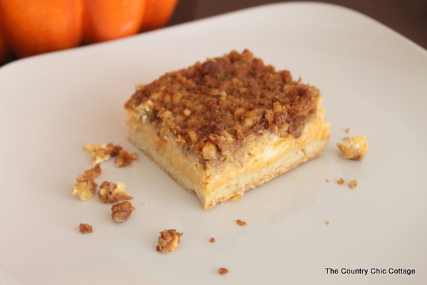 Crumb Topped Pumpkin Cheesecake -- make this wonderful fall dessert for your family this week. A wonderful pumpkin flavored cheesecake with a crunchy topping that includes walnuts and cinnamon. A perfect addition to your Thanksgiving feast! Let this one replace the standard pumpkin pie.