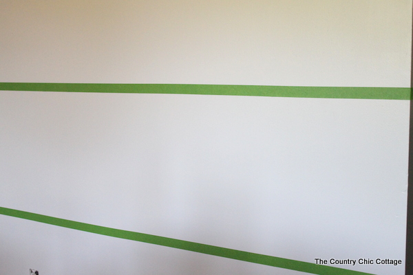 Apply the painters tape to your wall, using the markings you measured out.