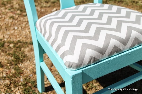 A DIY covered and painted chair using Glidden paints. Come learn more about resources for painting. close up of paint and reupholstered cushion