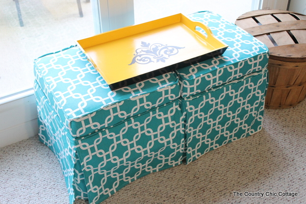 DIY Upholstered Coffee Table -- use reupholstered ottomans and a tray as a coffee table. Easy to do it yourself from thrift store finds!