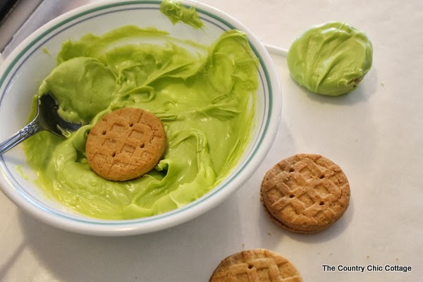 5 Minute Monsters Halloween Treat -- make these Monsters University themed Halloween treats in 5 minutes or less! green candy melts and cookies