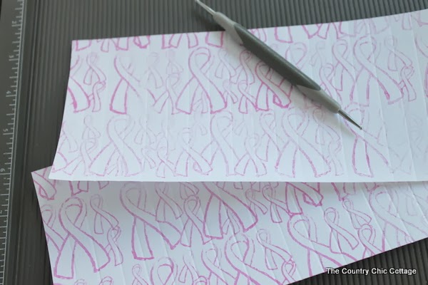 scoring breast cancer ribbon paper
