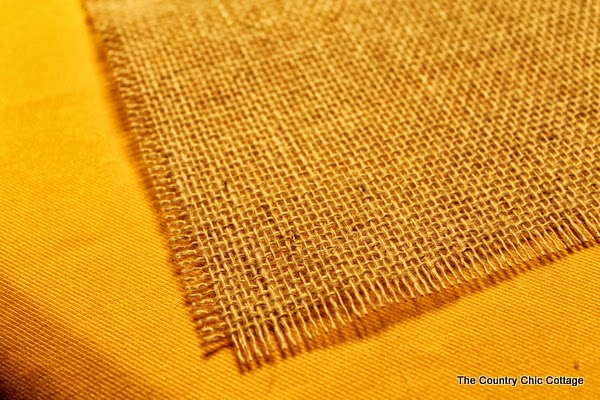 DIY Burlap Thankful Place Mats -- the perfect place mats to make for your Thanksgiving feast. Super simple to make and you can use the word "thankful" or the word of your choice. burlap on table