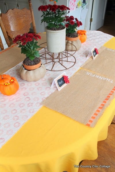 DIY Burlap Thankful Place Mats -- the perfect place mats to make for your Thanksgiving feast. Super simple to make and you can use the word "thankful" or the word of your choice. front view of burlap fall placemats on table