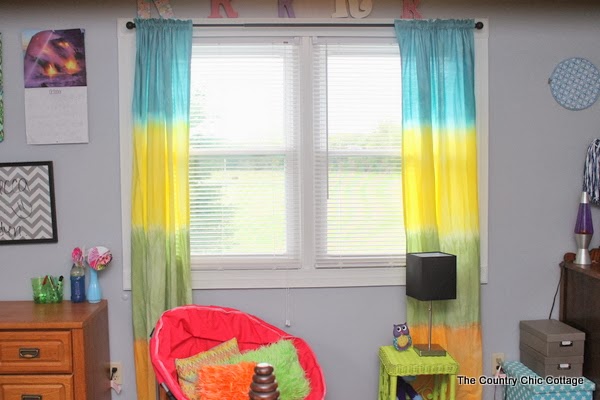 DIY Tie Dye Curtains -- learn how to make your own striped tie dye curtains in any color of the rainbow. These tie dye curtains are a fun DIY project that doesn't take long and is perfect for kids to join in on!