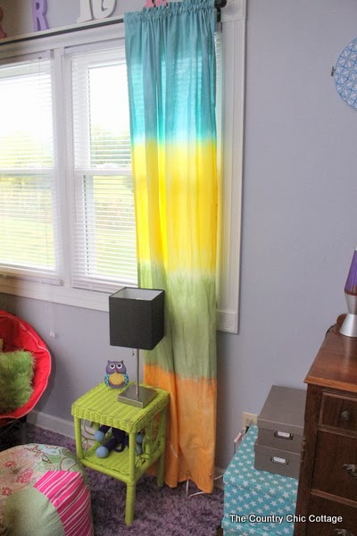 DIY Tie Dye Curtains -- learn how to make your own striped tie dye curtains in any color of the rainbow. Here's how to make DIY tie dye curtains that are perfect for your kids rooms.