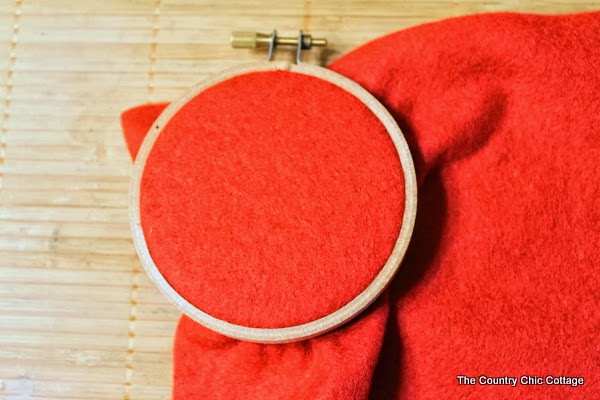 Red felt inside of an embroider hoop