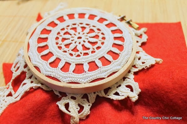 A hoop ornament with a doily on top 