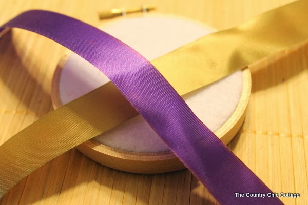 2 pieces of ribbon laying on a hoop ornament 