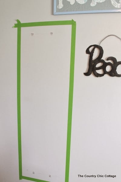 Painting frames around mirrors -- take plain build grade frameless mirrors and add flair for just the cost of paint. Come see how! Painter's tape on wall for painted mirror frame