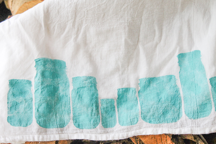 putting a stenciled design on a towel