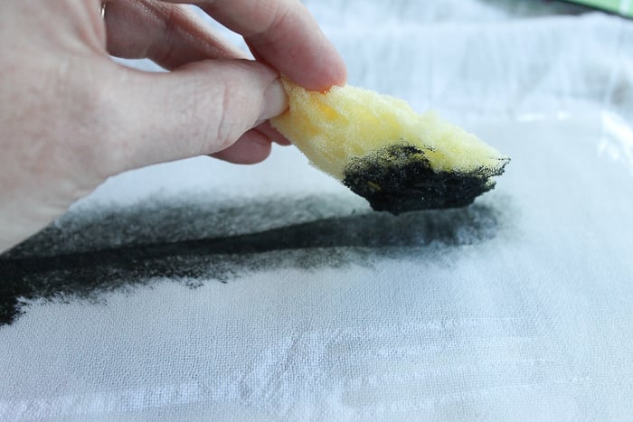 sponge painting ink onto a dish towel
