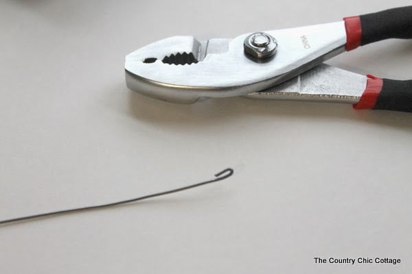 Button Candy Cane Christmas Ornaments -- handmade ornament tutorial that will have your tree full of button candy canes in no time. image of pliers and floral wire