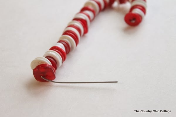 Button Candy Cane Christmas Ornaments -- handmade ornament tutorial that will have your tree full of button candy canes in no time. bending wire for white and red candy cane ornament