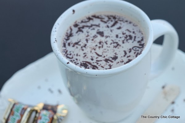 hot chocolate in white mug with chocolate shavings and milky way mini chocolates