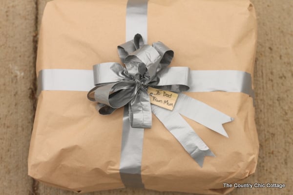 Gift wrap for men with duct tape -- a fun way to wrap gifts for guys! Learn how to make a bow from duct tape! DIY gift wrap for men with duct tape bow