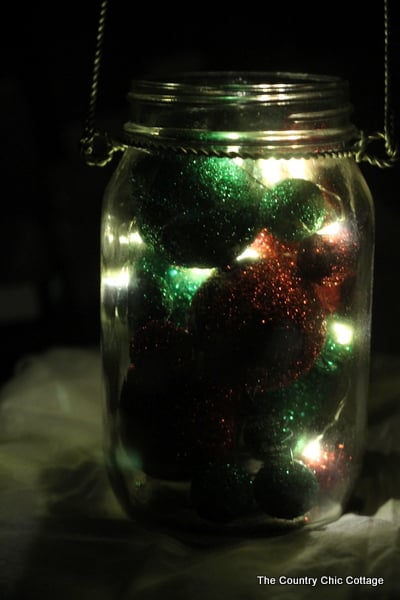 Glitter Mason Jar Christmas Luminary -- click the picture to get the full instructions on how to add this fun mason jar luminary to your Christmas decor.