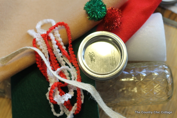 How to make an Elf Mason Jar Gift for Christmas -- learn how to make this fun craft for anyone on your gift giving list. Elf Mason Jar Gift idea craft supplies