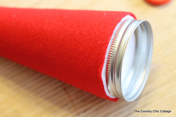 How to make an Elf Mason Jar Gift for Christmas -- learn how to make this fun craft for anyone on your gift giving list. attaching the lid to the bottom