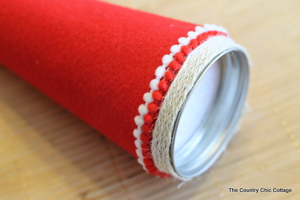 How to make an Elf Mason Jar Gift for Christmas -- learn how to make this fun craft for anyone on your gift giving list. attaching the pom pom fringe