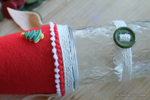 How to make an Elf Mason Jar Gift for Christmas -- learn how to make this fun craft for anyone on your gift giving list. attaching belt and decoration for the hat