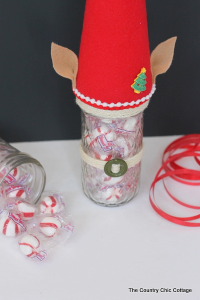 How to make an Elf Mason Jar Gift for Christmas -- learn how to make this fun craft for anyone on your gift giving list. Elf Mason Jar Gift for Christmas