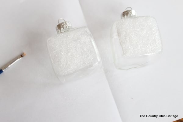 Kids Craft: Mini Snow Globe Ornaments -- click the picture to get the full instructions for making your own fun Christmas ornaments. adding decoupage and glitter onto ornaments