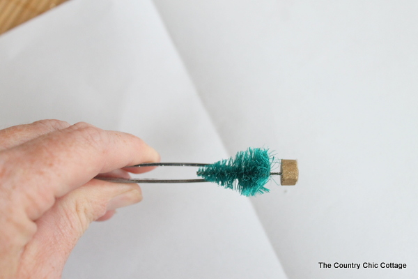 Kids Craft: Mini Snow Globe Ornaments -- click the picture to get the full instructions for making your own fun Christmas ornaments. tweezers picking mini trees