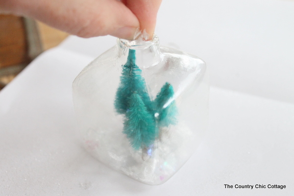 Kids Craft: Mini Snow Globe Ornaments -- click the picture to get the full instructions for making your own fun Christmas ornaments.